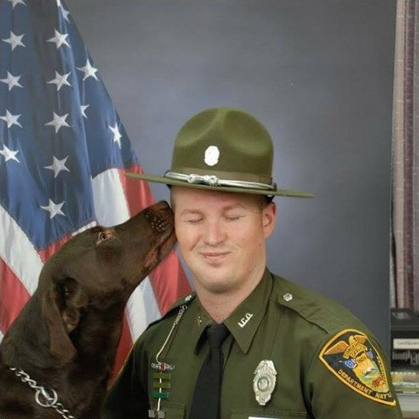 During their photo session, the loyal K9 partner keeps sneaking in kisses for his handler, beautifully capturing their unbreakable bond