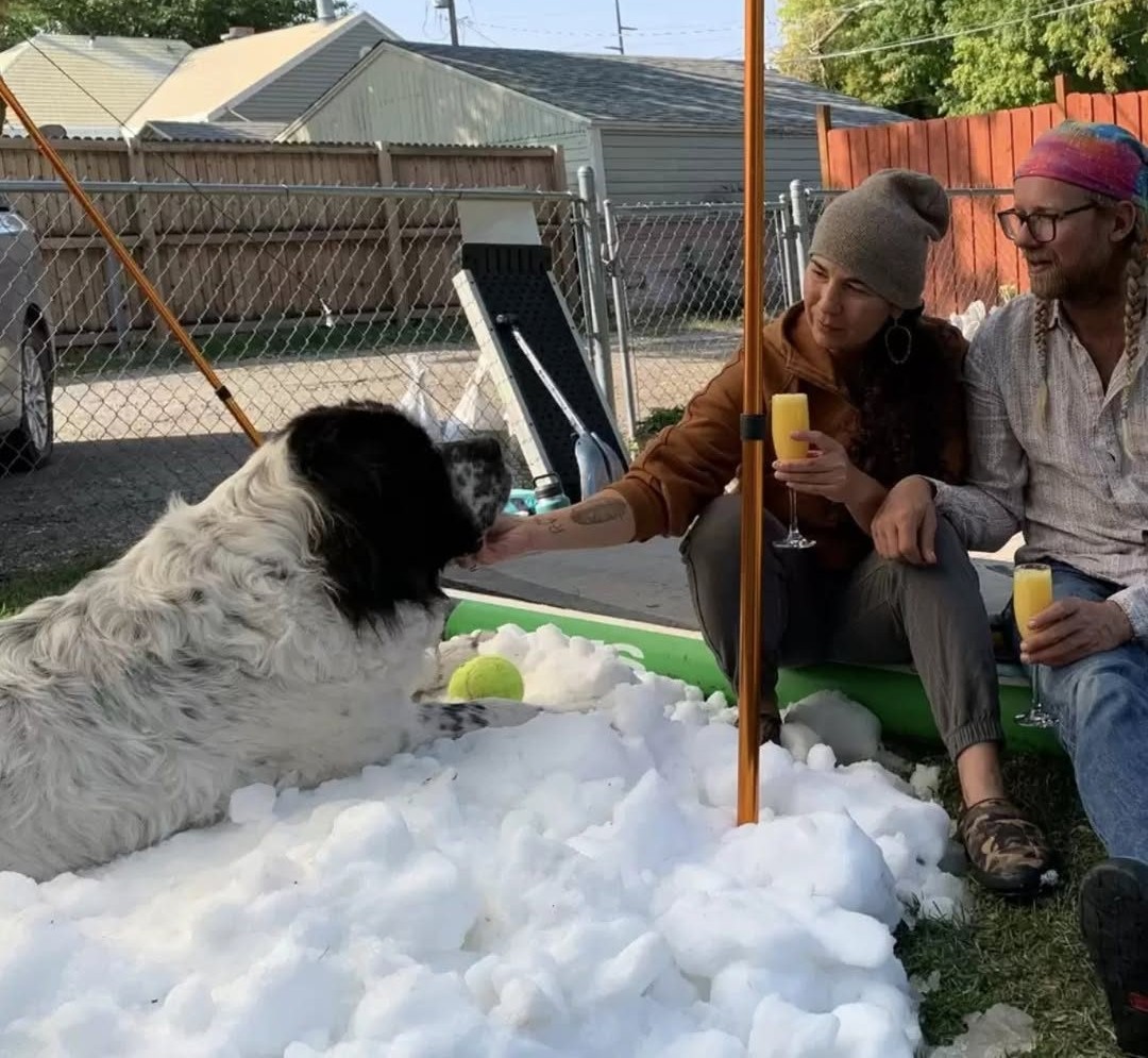 Family Makes A Mountain Of Snow In Their Yard So Their Dog Can Play In It One Last Time